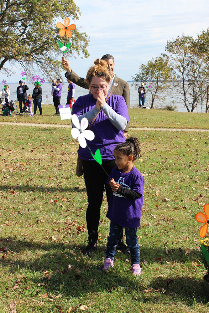 A child held a white flower as a symbol of finding a cure for Alzheimer’s at the Anne Arundel County 2022 Walk to End Alzheimer’s, which took place October 16.