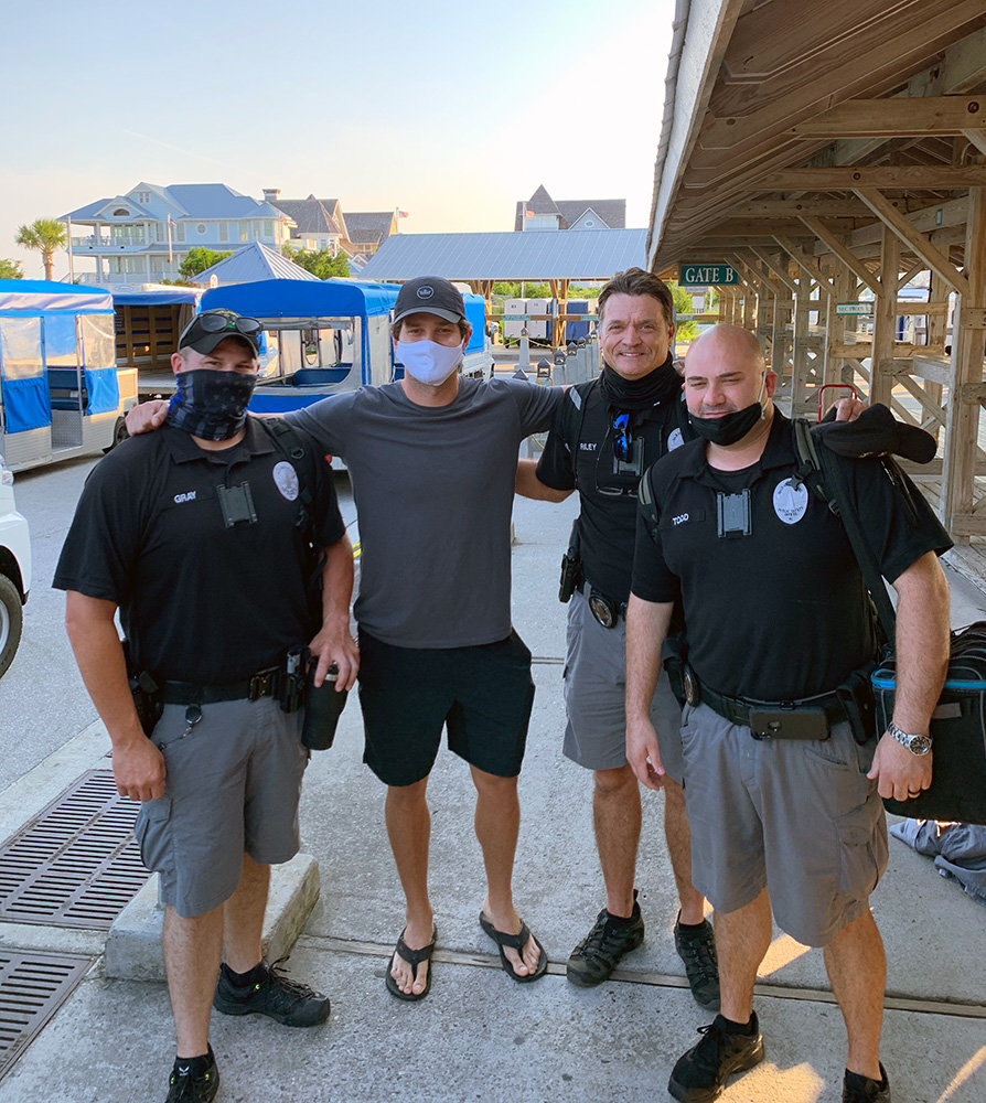 Chandler Watson was pictured with paramedics at Bald Head Island, North Carolina, the day after his shallow water blackout.