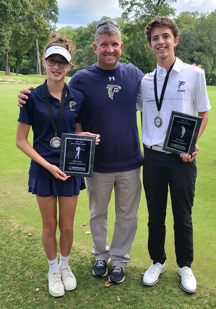 Severna Park golfers Nicol Chovanec (left) and DA Regala (right) celebrated with coach Pete Buck after winning their individual county championships in September.
