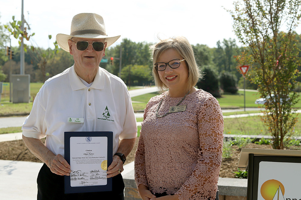 Ed Parker received a citation from Councilwoman Amanda Fiedler during an October 2021 dedication for a new area, the Jean and Edgar Parker Memorial Rest Area, along the Broadneck Peninsula Trail.