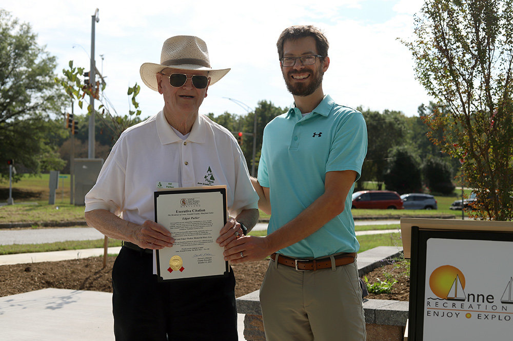 Ed Parker received a citation from Chris Trumbauer during an October 2021 dedication for a new rest area along the Broadneck Peninsula Trail. Trumbauer is a budget officer and senior policy advisor to the county executive.