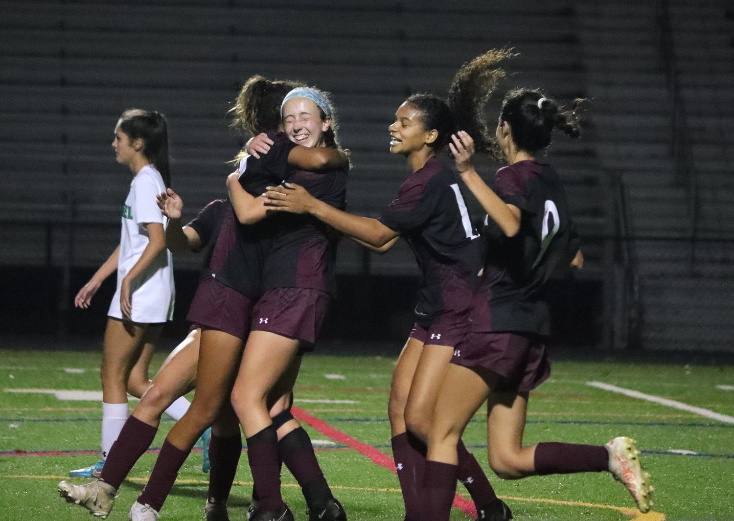 Aurora Nelson (blue headband) celebrated her goal with teammates with about 10 minutes left in the first half.