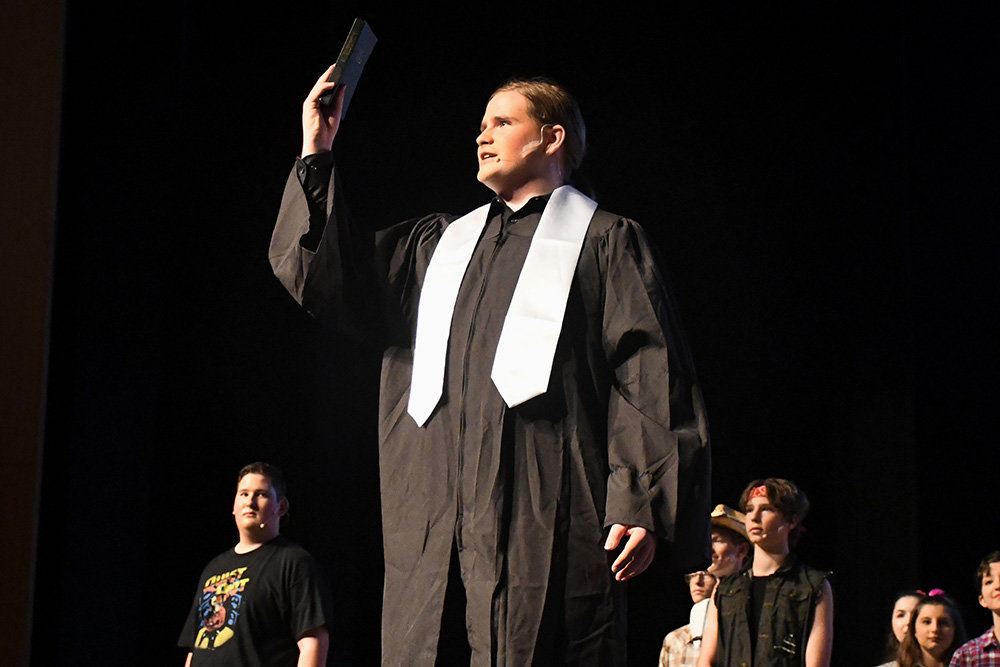 Reed Estepp, portraying Reverend Shaw Moore, delivered a fiery sermon to his congregation during the Severna Park High School production of "Footloose." Estepp impressed the audience during his first theatrical performance with his emotional gravity and clear tenor voice.