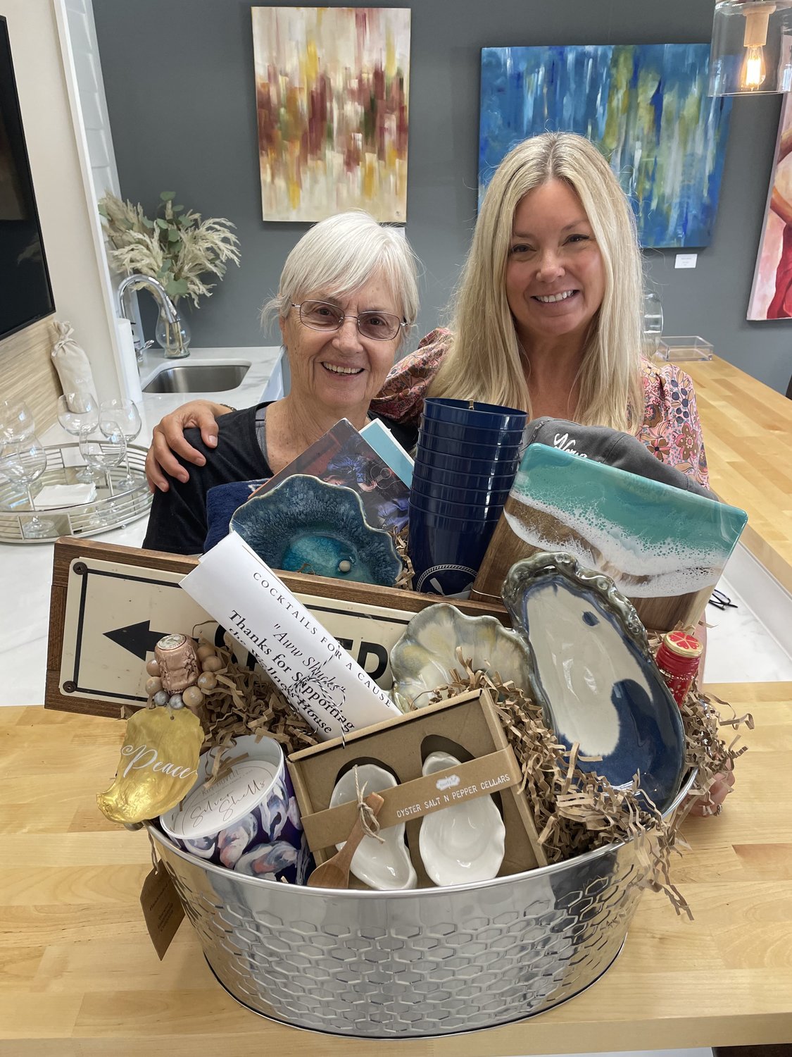 Priscilla Kania of Arnold (left) won the raffle and was congratulated by Tina Bradshaw, partner of the SnyderlBradshaw Group.