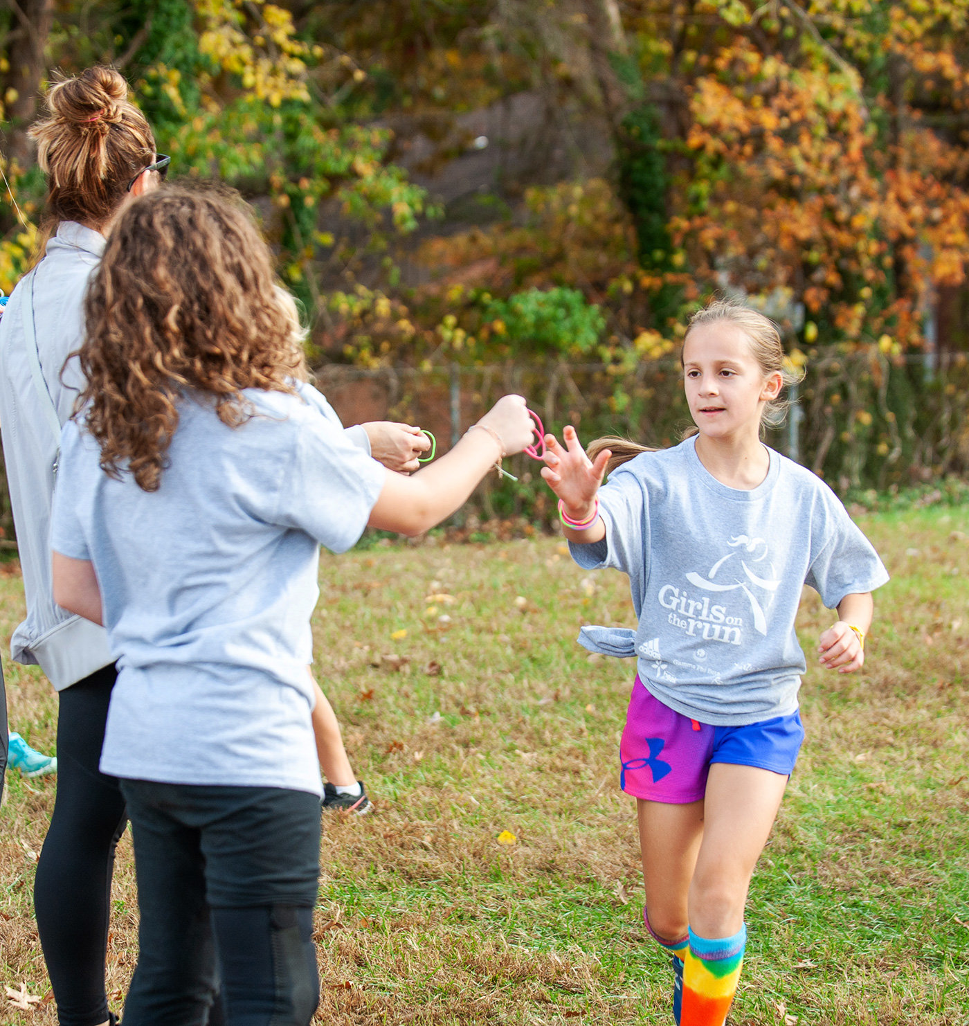 Parents gave Sloane DeCosmo bracelets as she completed a lap during a 5K at Oak Hill Elementary.