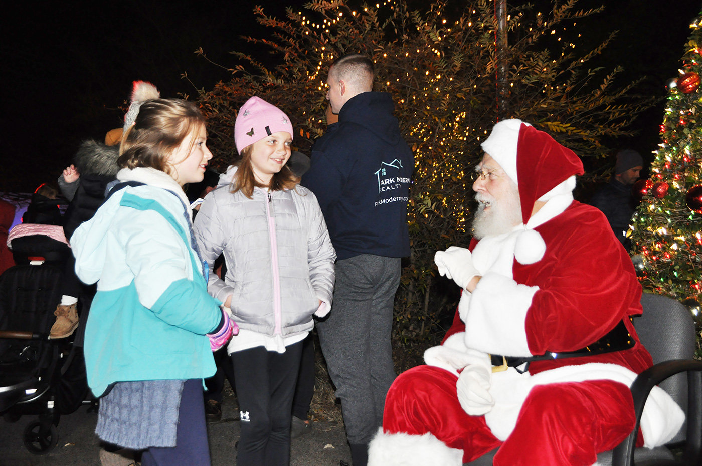 Santa enjoyed a conversation with Clara Berthelotte (left) and Ellie Reneau (middle).