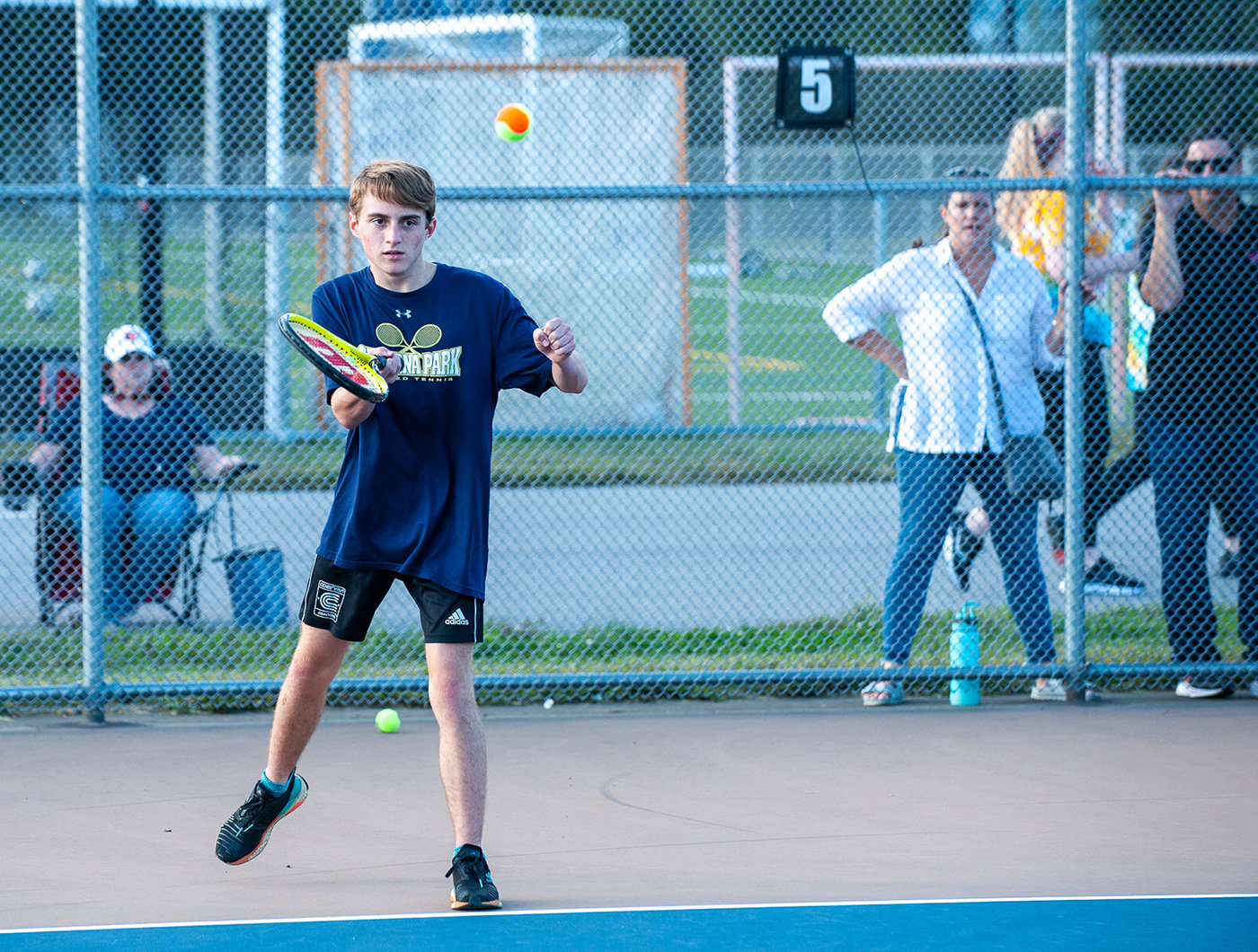 William Stimpson enjoys the challenge of playing tennis teams at other schools. During a fall match, he served the ball to a Northeast opponent.