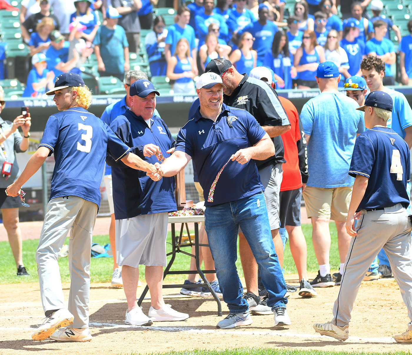 Retiring Severna Park High School Principal Patrick Bathras (center, right) often attended sporting events, like the 2022 baseball state championship game in Waldorf, to support his school’s athletes.