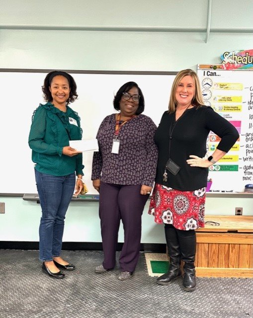Services from the Heart founder and president Donna Wilson-Johnston, Oak Hill financial secretary Bernadette Jackson and second-grade teacher Pat Anderson presented the check.