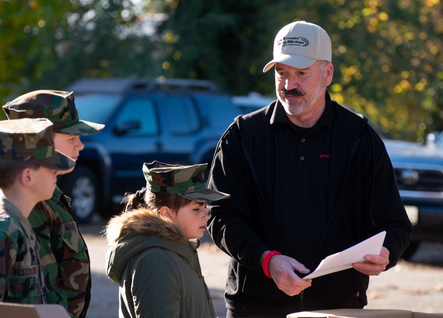 Ray Sturm gave directions to several members of the Young Marines organization during a recent event. Sturm serves as the commander of the Anne Arundel Young Marines.