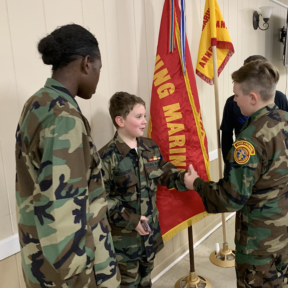 Severna Park resident Caleb Missimore, center, was welcomed into the Young Marines at a winter meeting.