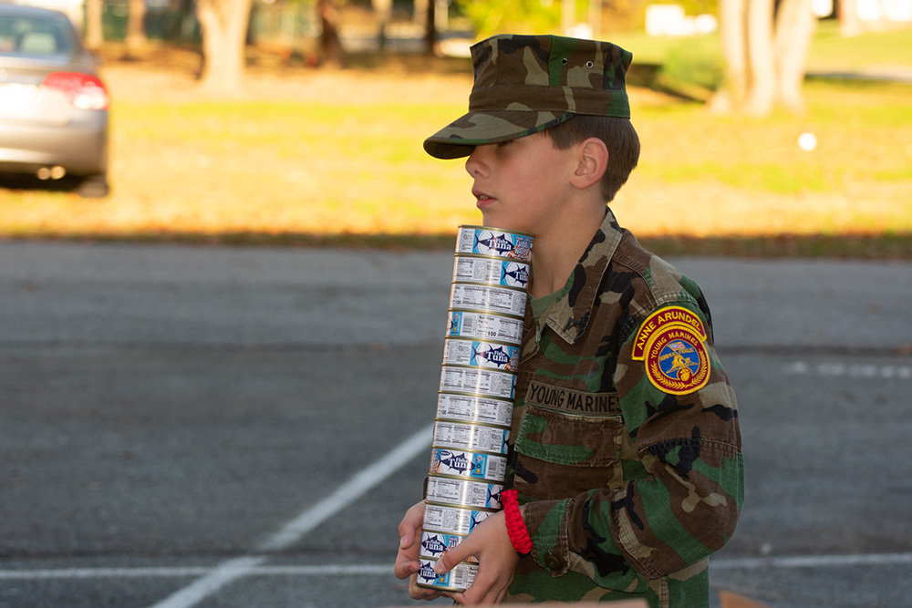 Daniel Westerlund, a lance corporal with the Young Marines program, carried cans of tuna for the Anne Arundel Young Marines.