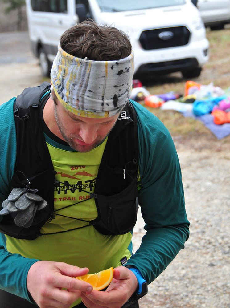 Justin Peake stopped to recharge at an aid station during last month’s Hellgate 100K in Fincastle, Virginia.