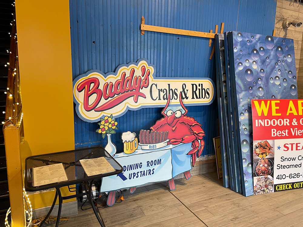 Buddy's Crabs & Ribs presents a laid-back atmosphere with smiling crab caricatures and decor.