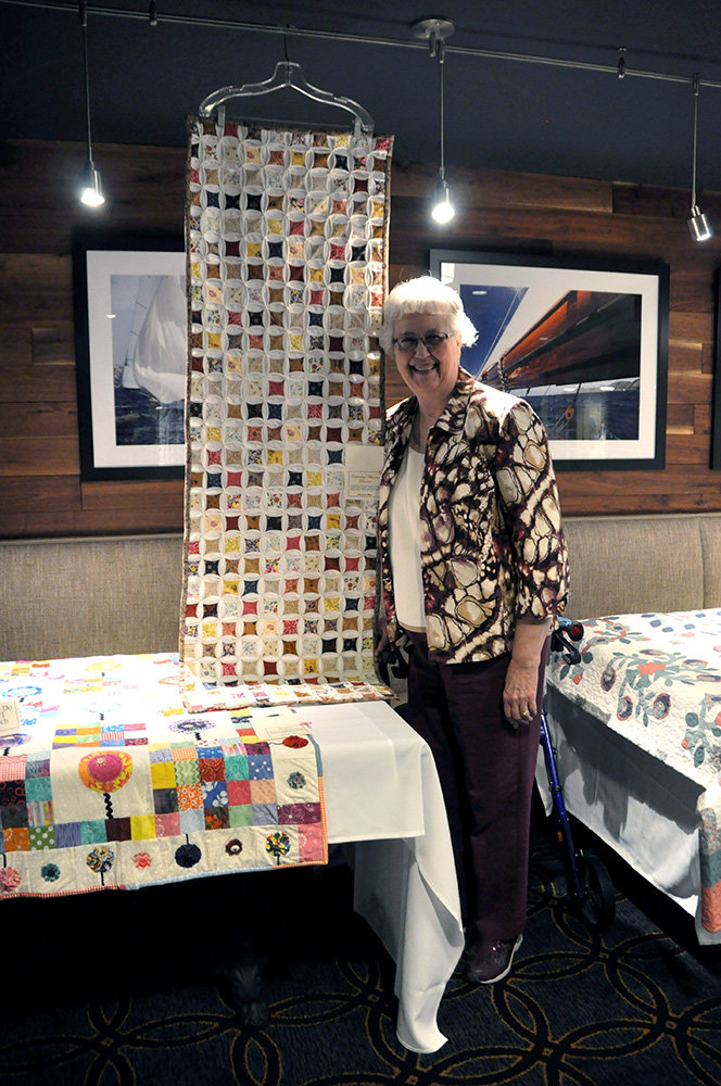 Brightview Severna Park resident Sherry Moe stood in front of her quilt at the recent resident art show.