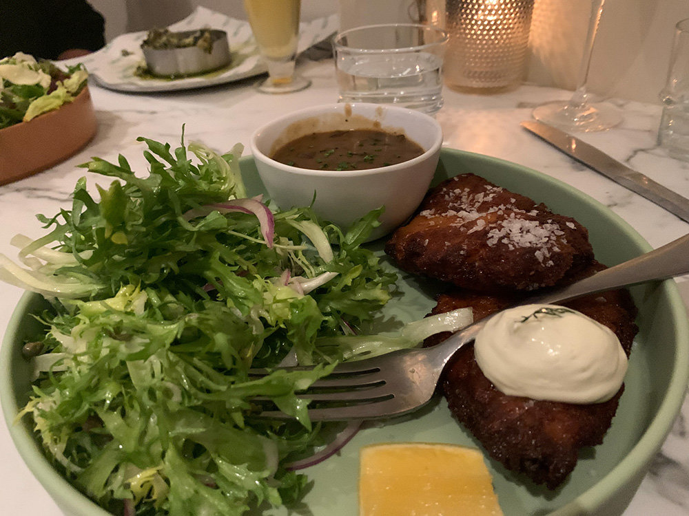 Chicken schnitzel is a signature dish at Garten. The meal includes brined, lightly breaded chicken and a side salad. The jager sauce is worth $4.