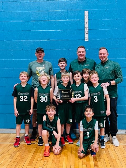 The Green Hornets select 8U team included (front row, l-r) Michael Duffy and Leo Matthews, (second row, l-r) Brian Staples, Joaquin Richardson, Will Young, Penn Shaklee, Nick Chase and Ezra Buterbaugh and (third row, l-r) assistant coach Glenn Staples, Channing Patterson, head coach Ryan Young and assistant coach Damion Buterbaugh.