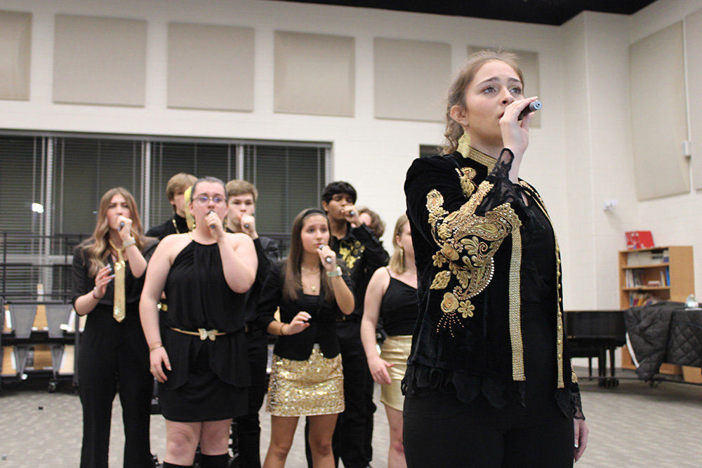Senior Gianna Dicks (right) rehearsed with Sol prior to the a cappella group’s performance at the ICHSA quarterfinals.