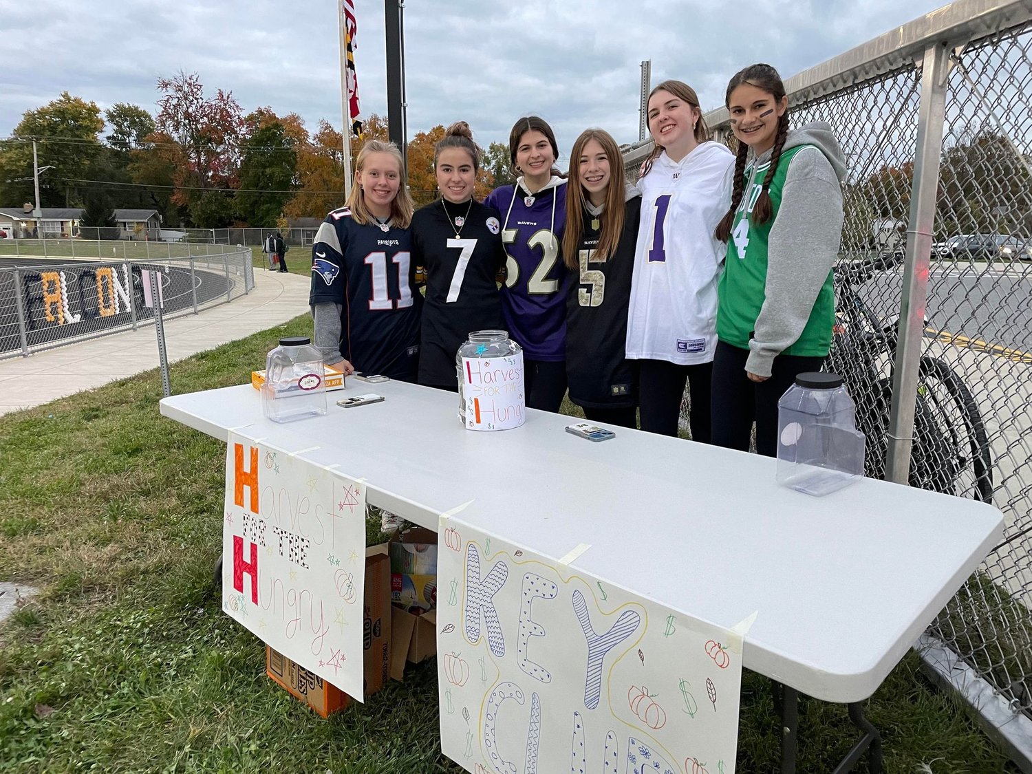 Josie Garrett, Jaidyn Jarrett, Natalie Frank, Jillian Kules, Tori Wright and Lily McCallister geared up to collect money for Harvest for the Hungry during a home football game in October.