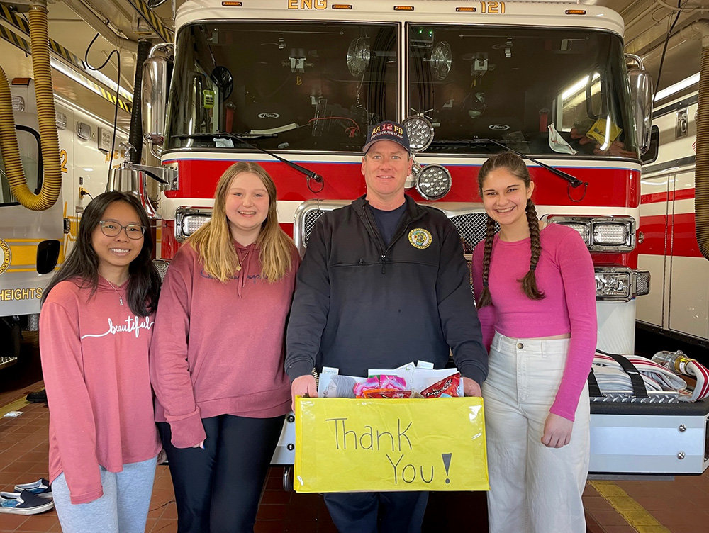 Earleigh Heights Volunteer Fire Company’s Brent Franklin accepted a hero basket from Addie Faust, Jessica Bui and Lily McCallister on behalf of the station.