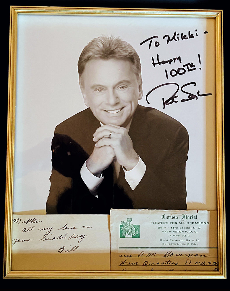 “Wheel of Fortune” host Pat Sajak signed a photo and penned a note to Mikki for her recent 100th birthday celebration.