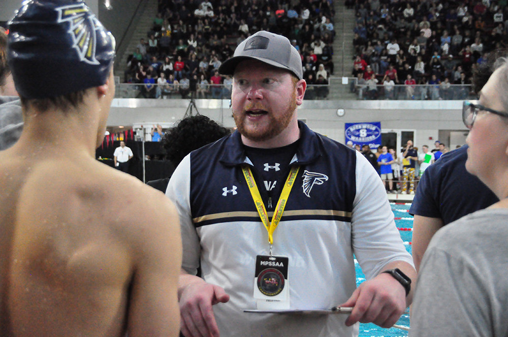 Severna Park High School head swim coach Trevor Brinton chats with a swimmer at the 2023 Maryland Public Secondary Schools Athletic Association Swimming and Diving State Championships last month.