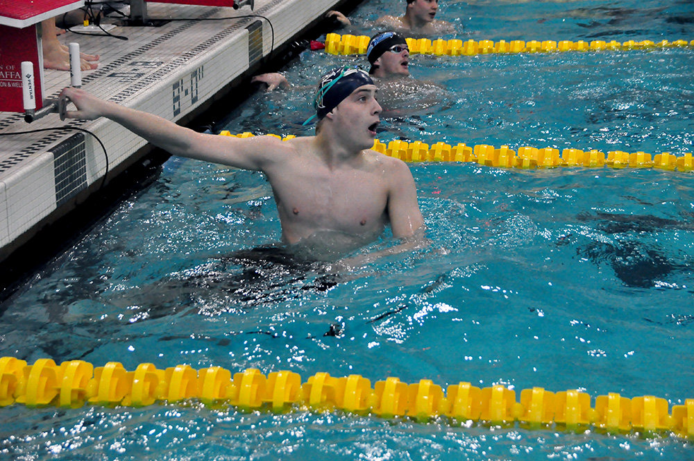 Severna Park’s Morgan Sloan checks his team’s time following the 200-yard freestyle relay during last month’s high school swimming and diving state championships.