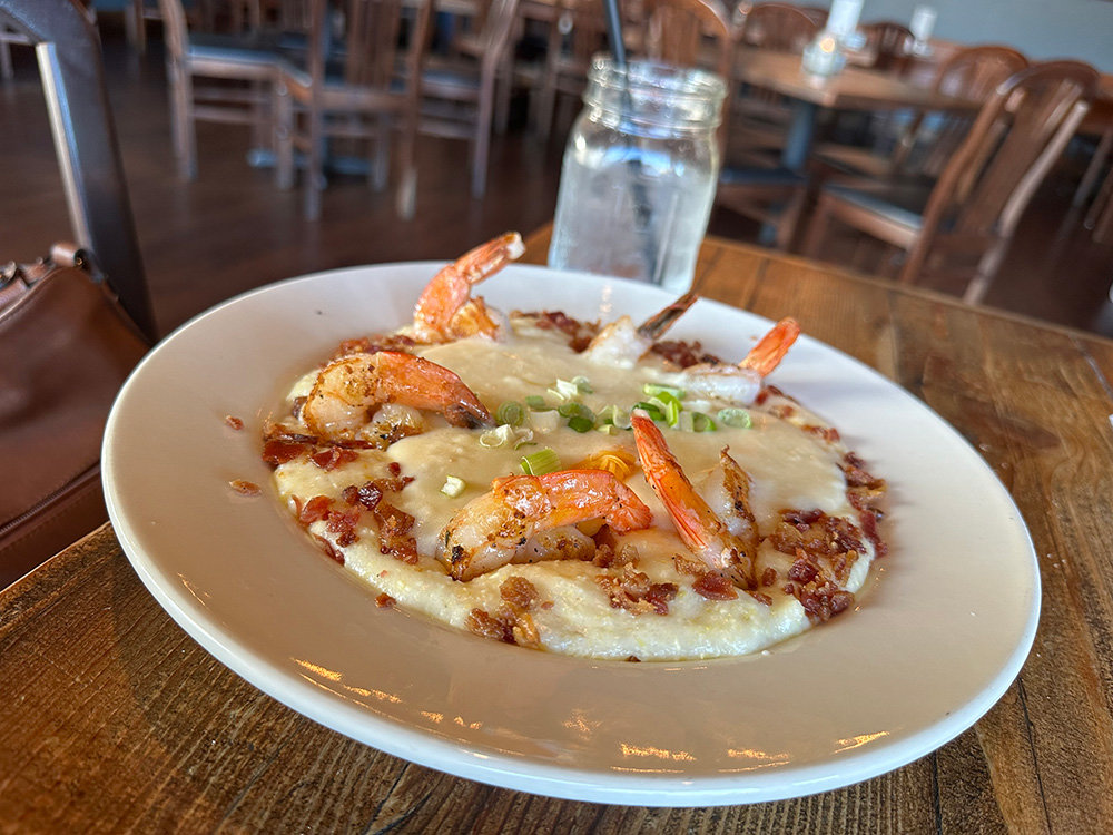 The shrimp and grits meal included large gulf shrimp, topped with South Carolina grits and covered with chicken gravy, with bacon bits and scallions.