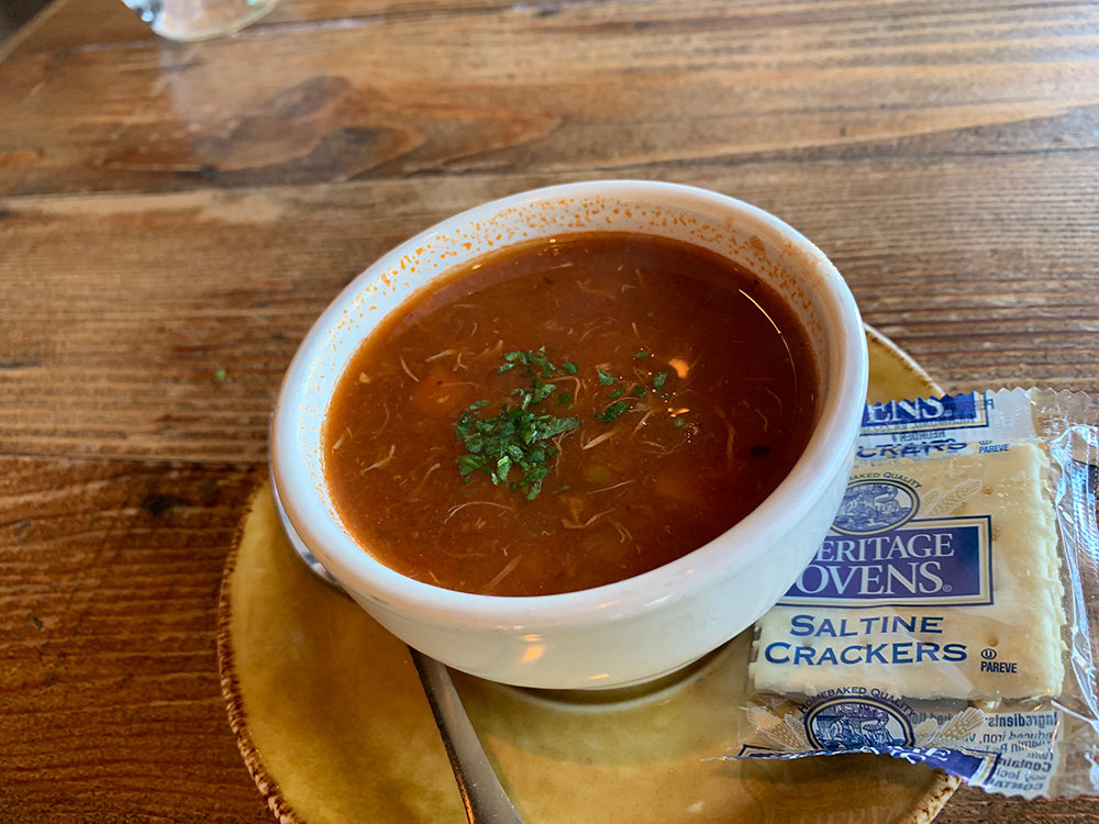 Founders is known for its crab soup. The satisfying appetizer has homemade seasonings, tomatoes, potatoes, green beans, and crab.