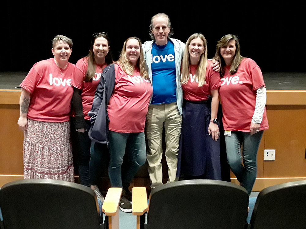 Several teachers gathered after the assemblies at Severna Park High School to show their support for David Flood’s message of kindness.