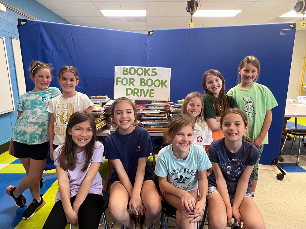 Troop 2096 members included (l-r) Madison Duffy, Eleanor Rivera, Audrey Tong-Holcomb, Peyton Menefee, Maeve Helin, Hannah Fitzpatrick, Emily Walsh, Mary Marshall and Allison Augelli. Ariana Marshall and Allison Holcomb served as troop leaders, and Blakeley Fitzpatrick contributed her time as book drive parent volunteer.