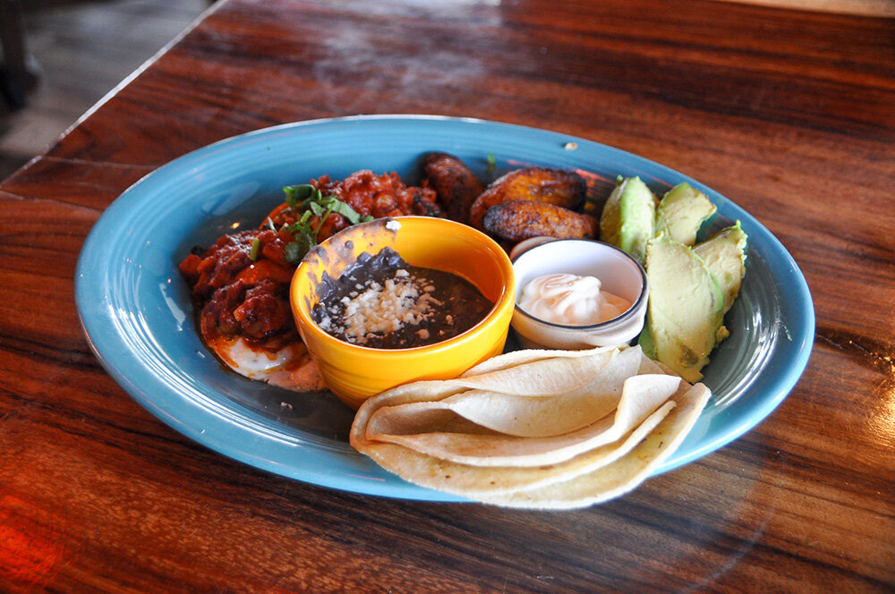 The huevos rancheros meal comes with two eggs, topped with salsa, beans, avocado, queso fresco and tortillas.