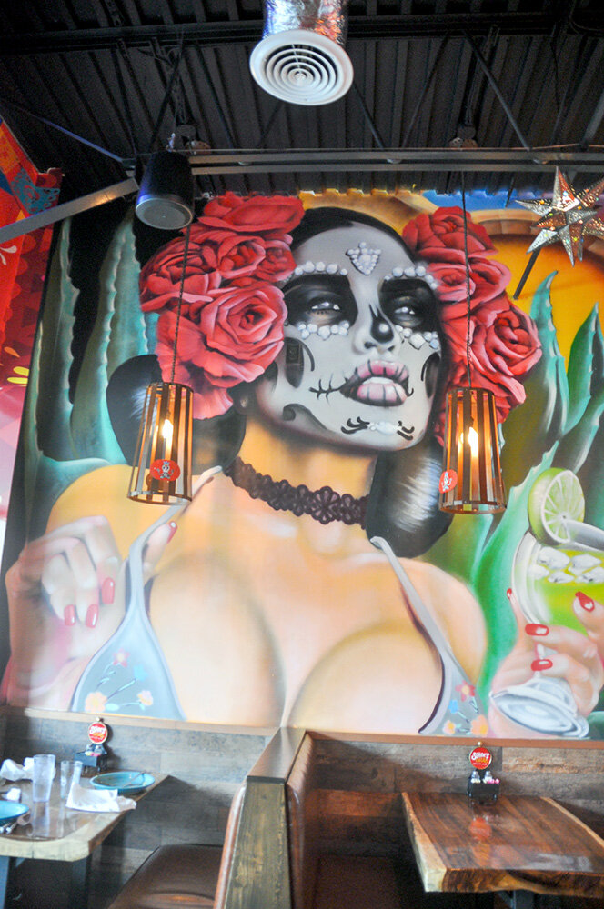 This mural of a woman sporting skeletal face paint, drink in hand, is a defining characteristic of the Severna Park restaurant.