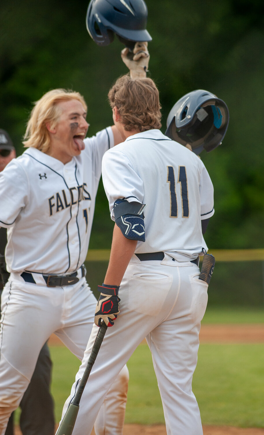 Kody Phillips (left) celebrated with Nate Clarke (11) after hitting a home run during the first inning.
