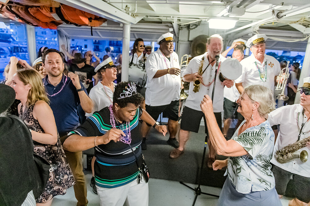 Passengers danced to music performed by Naptown Brass Band aboard the Harbor Queen at a Watermark cruise event.