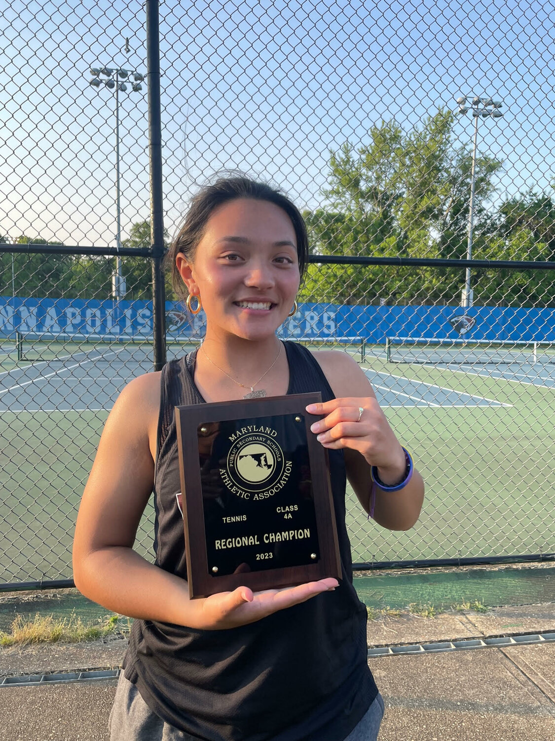 Elicia Aponte showcased her regional champion plaque, earned from her mixed doubles victory.