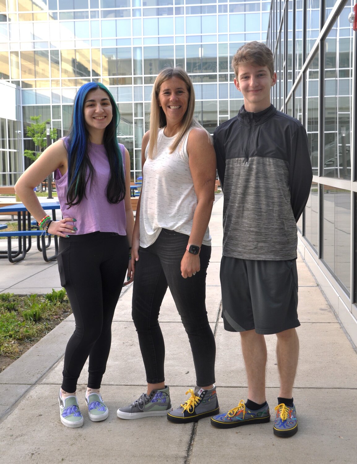 Severna Park High School principal Lindsay Abruzzo stood between senior Nadia Abdolahi and sophomore Jameson Murray, the winners of the school’s Vans shoe design contest. Abruzzo was sporting Nadia’s shoe design on one foot and Jameson’s design on the other.