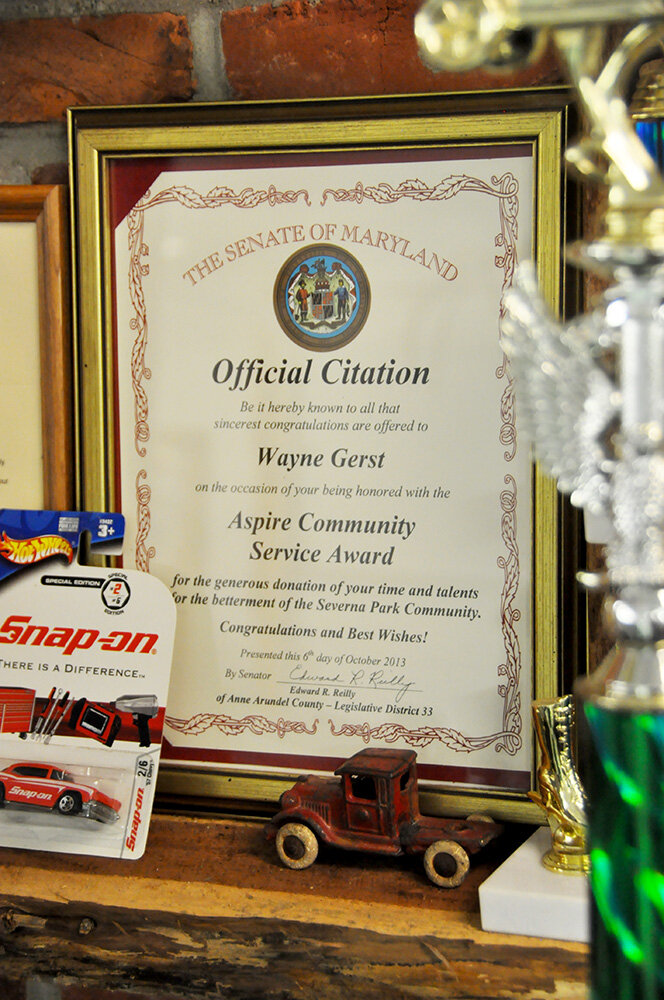A community service award is one of many recognitions on display in Wayne Gerst’s garages.