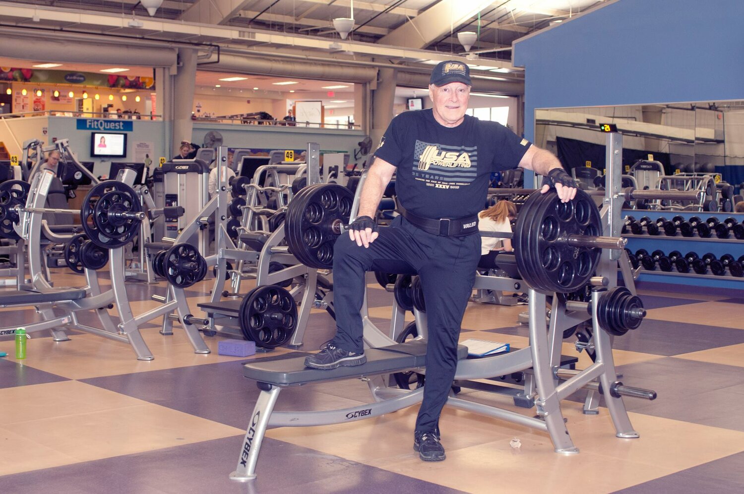After overcoming multiple forms of cancer, Chuck Mulligan continues to bench press at the Y in Arnold.