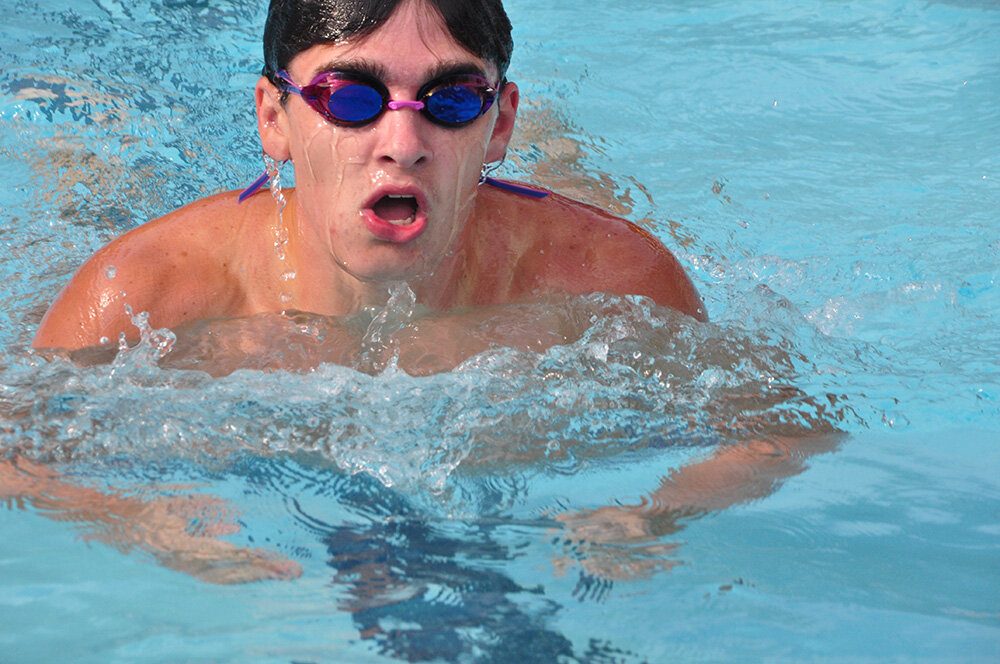 Nathan Kohler of the Tidal Waves took a breath during the breaststroke portion of the boys 15 and over 100-meter individual medley.