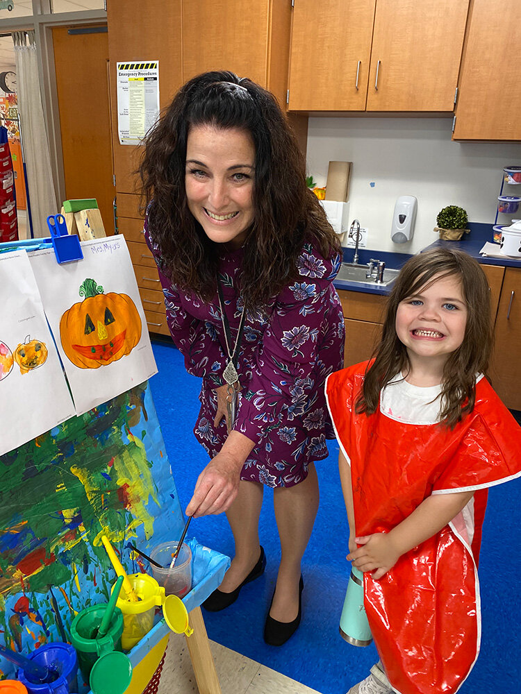 Benfield Elementary School Principal Sue Myers admired the work of first-grader Poppy Sprinkel.