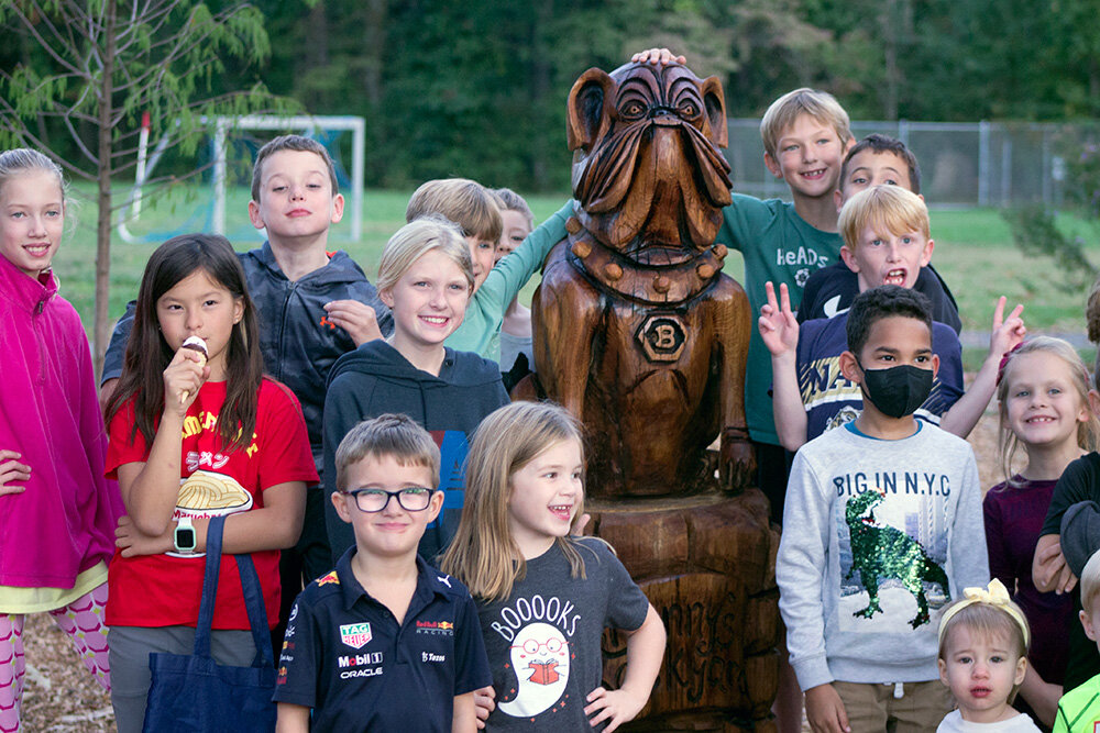 Kids surrounded the new playground statue during an ice cream social and celebration on October 11.