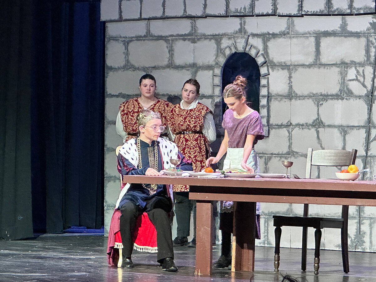 Prince John was helped by a servant while his two guards watched. Actors in this scene included Teagan Yokanovich (back left), Brayden McDowell (front left), Iz Taylor (center) and Vida Sullivan.