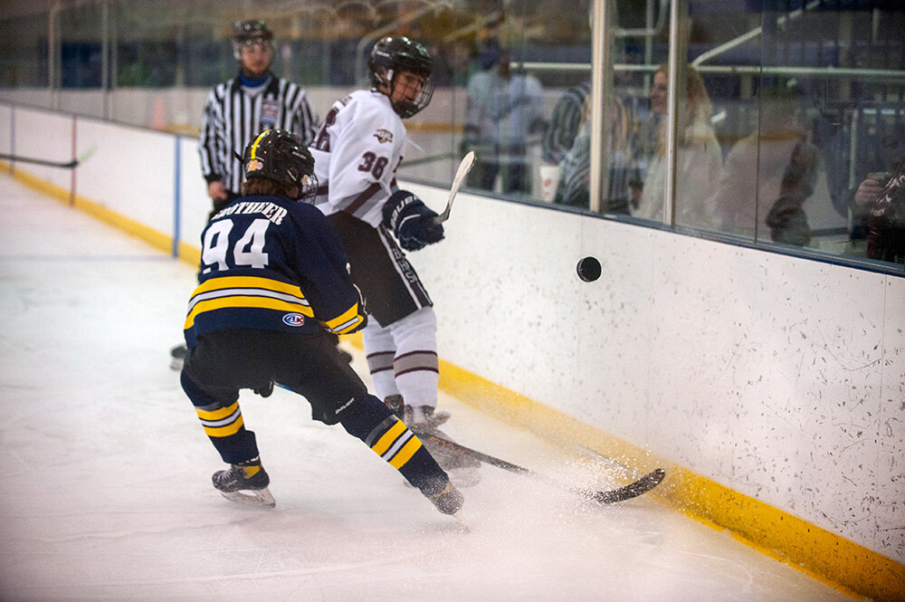 Severna Park's Griffin Grotheer (94) and Broadneck's Ryan Kucharski (36) jostled for the puck during their game on December 19 at the Brigade Sports Complex.