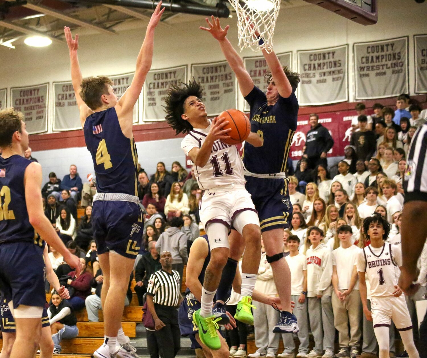 Broadneck’s Jordan Brown (11) went up for a shot against the defense of Severna Park’s Tucker Moran (4) and Liam Cleary (0).