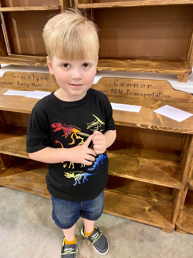 Conner Morse, four-year-old son of Conner and Ashley Morse, received his personalized bookshelf from M&amp;M Transportation at a Stockton Head Start presentation April 27 at the Zumwalt Expo Center.