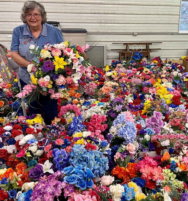 El Dorado Springs Progress Club President Becky Gazaway works her way through thousands of recycled flowers as the club prepares for one of their biggest fundraisers of the year.