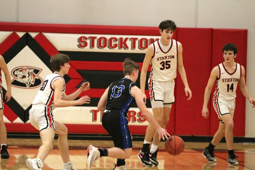 Colter Woods (left), Jax Baxter (#35) and Logan Reser (#14) play defense against the visiting Morrisville Panthers last week. Stockton scored two victories to end the regular season