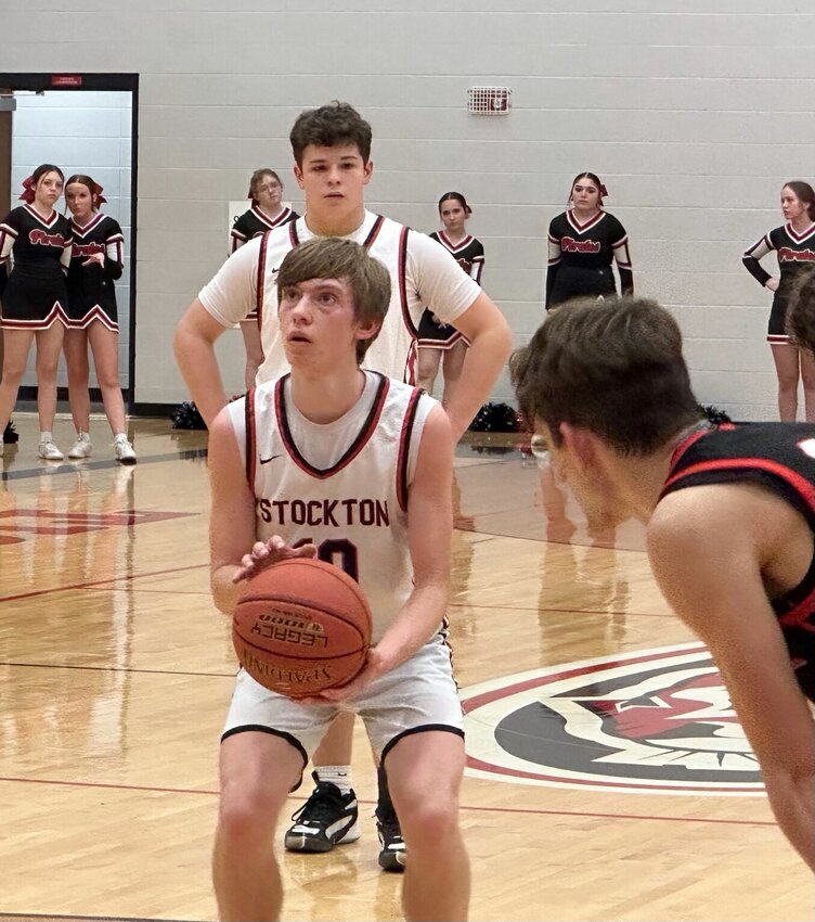 Colter Woods shoots a free throw against Ash Grove last week as teammate James Flora looks on. The shorthanded Tigers came up just short in their upset bid.
