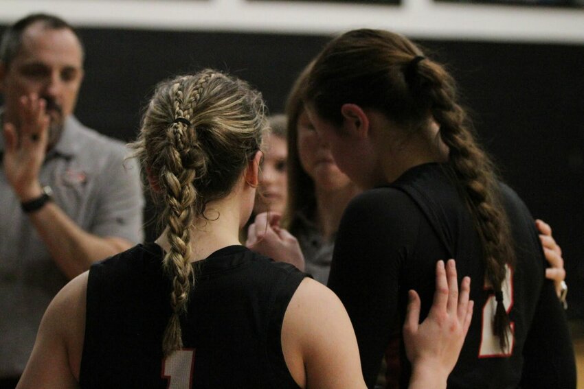 An emotional Ellie Flora is consoled by teammate Raelyn Henderson last Friday as the Lady Tigers&rsquo; season came to a close with a Class 3, District 13 championship loss to Cedar County foe El Dorado Springs. The Lady Bulldogs defeated the Lady Tigers, 70-39